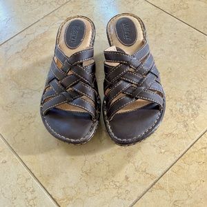 Born: Size 6 Women’s brown leather criss cross slide on sandals w/tan stitching.